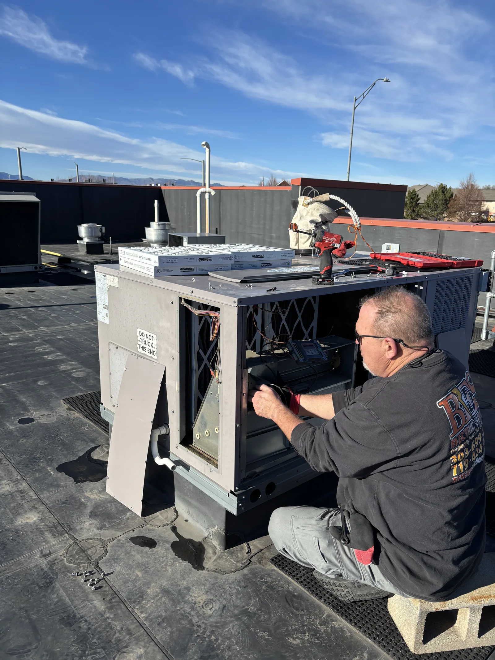 BES techs servicing a commercial rooftop unit
